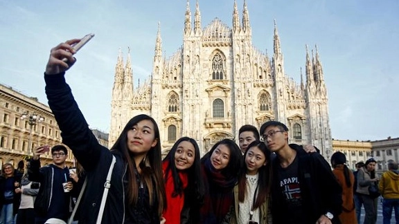 Un gruppo di turisti cinesi si fa un selfie in Piazza del Duomo: il numero di visitatori dal Paese del Sol Levante sta per tornare ai livelli pre-pandemia