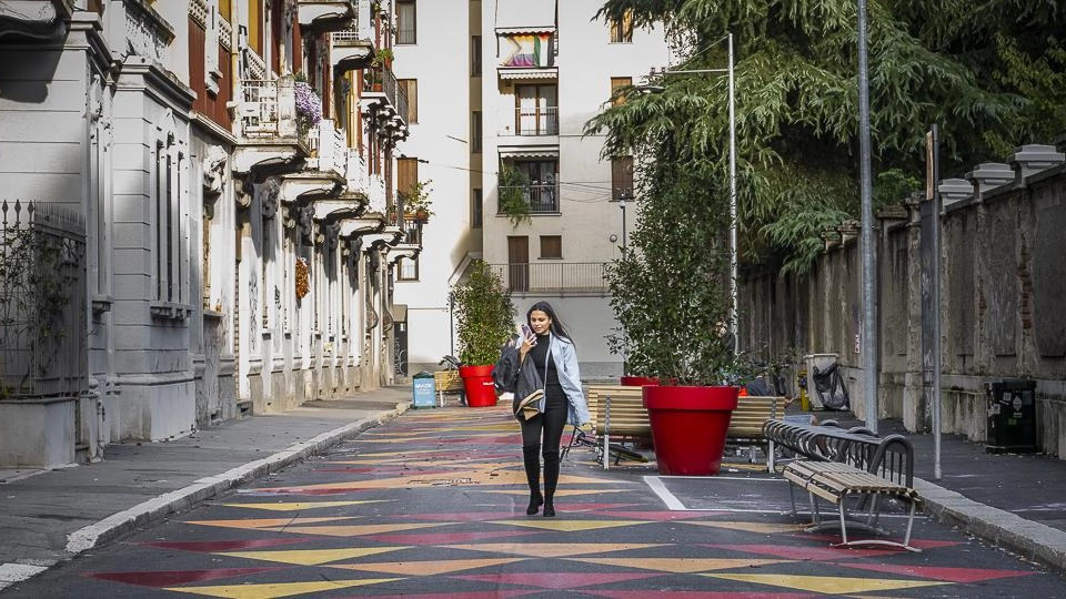 Il Comune riqualifica via Bernardino de Conti con la creazione di una colorata "Piazza Aperta" per offrire uno spazio sicuro agli alunni. Residenti apprezzano ma segnalano problemi di utilizzo e sicurezza.